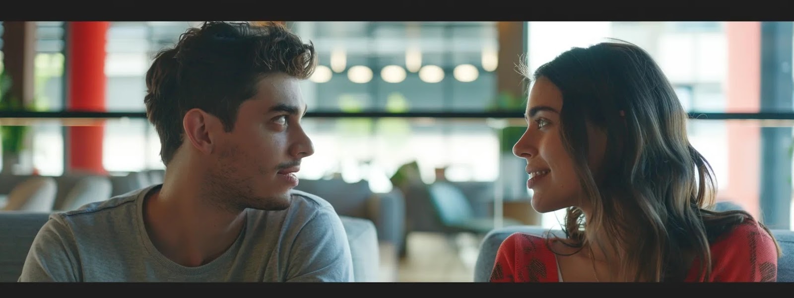 a couple sitting facing each other, making eye contact and engaged in deep conversation.